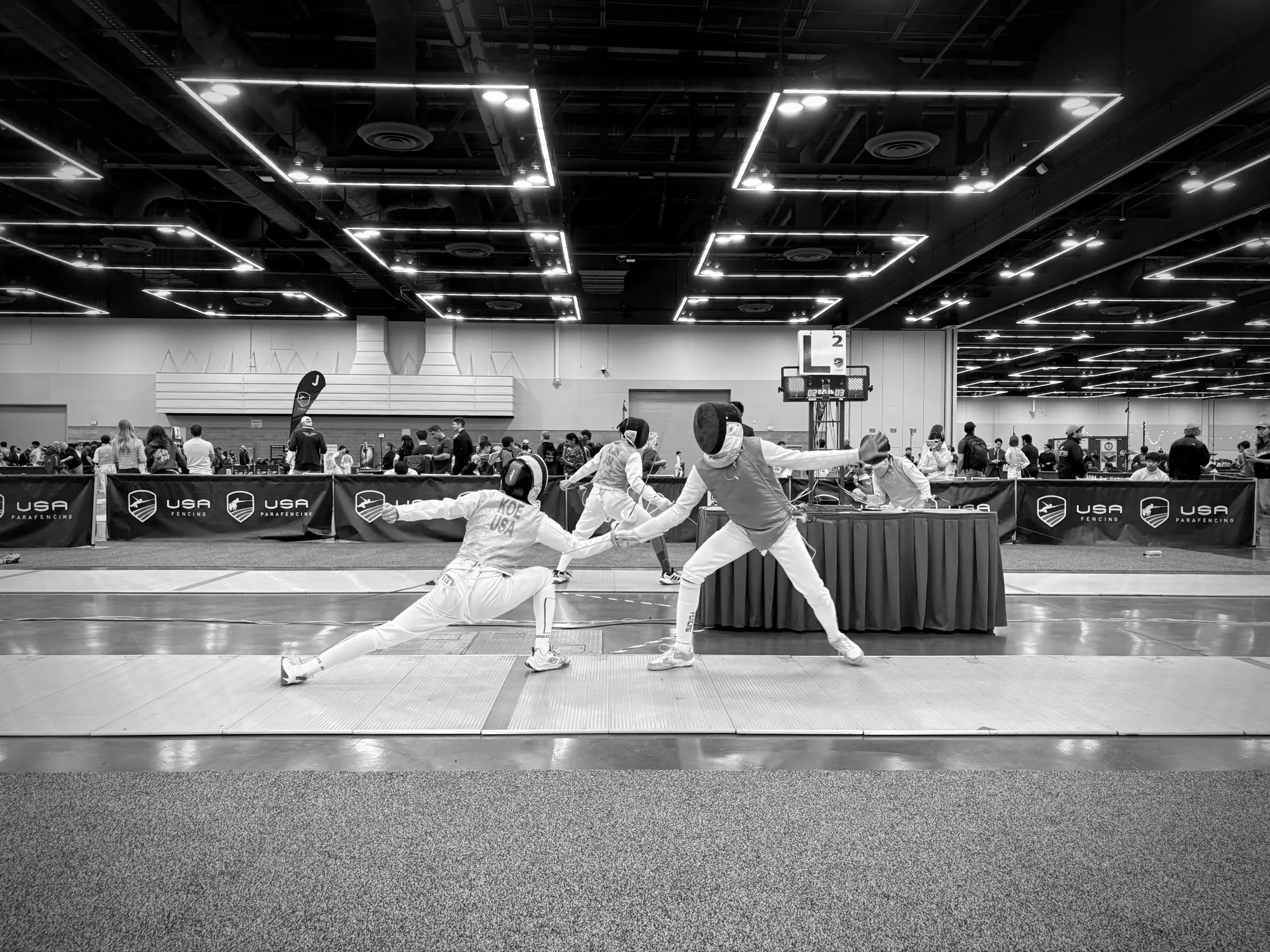 A Fioretto fencer lunges for the touch at a USA Fencing tournament